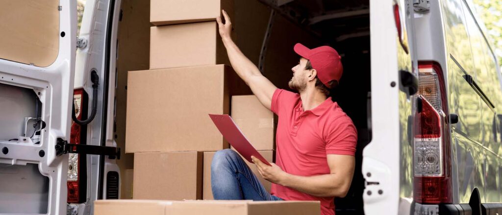 Man organizing inventory in a storage area, representing efficient SKU rationalization for e-commerce businesses.