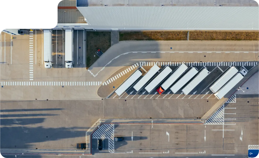 Home - Indonesia 11 aerial shot of big warehoue with trucks parked outside