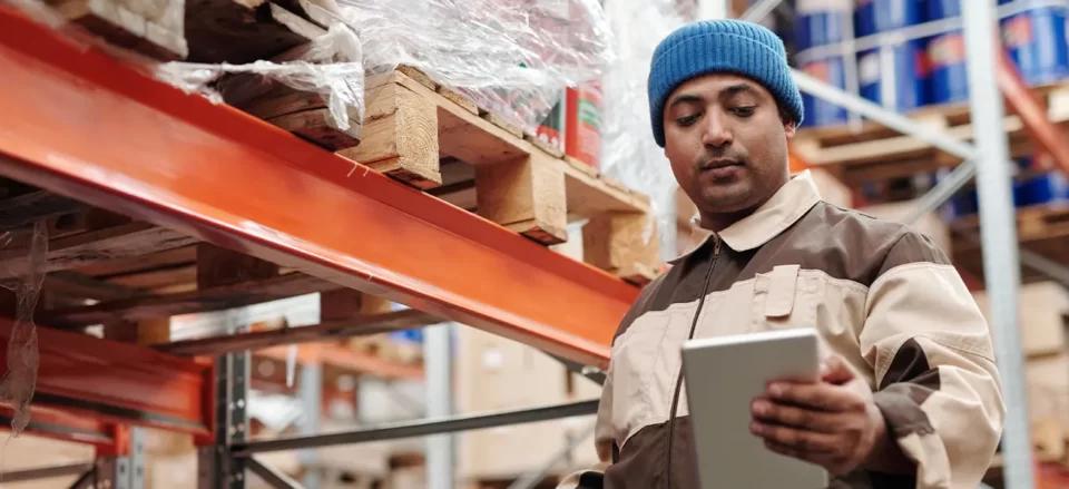 E-commerce warehouse representative looking at last mile delivery checklist | Locad