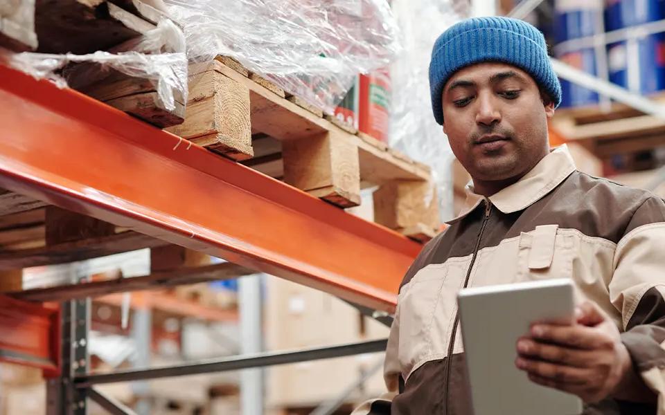 E-commerce warehouse representative looking at last mile delivery checklist | Locad