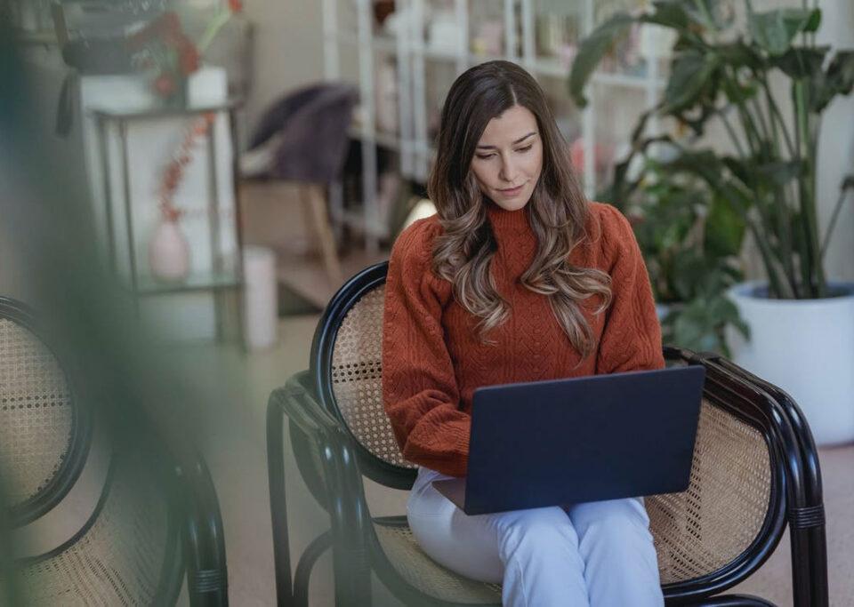 woman e-commerce business owner typing on her laptop